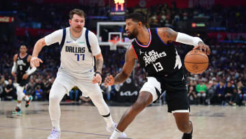 Los Angeles, California, USA; Los Angeles Clippers forward Paul George (13) defended by Dallas Mavericks guard Luka Doncic (77)