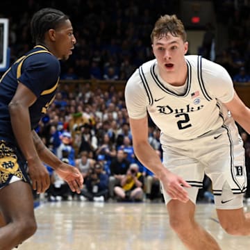 Jan 11, 2025; Durham, North Carolina, USA;  Duke Blue Devils forward Cooper Flagg (2) drives to the basket as Notre Dame Fighting Irish guard Markus Burton (3) defends during the first half at Cameron Indoor Stadium. Mandatory Credit: Rob Kinnan-Imagn Images