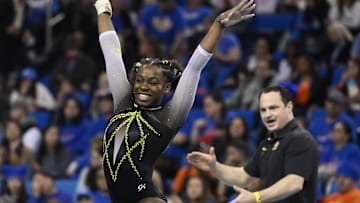 Mar 30, 2023; Los Angeles, CA, USA;  Amari Celestine of Missouri completes her floor exercise routine as coach Shannon Welker applauds during the NCAA Women's Gymnastics Los Angeles Regional at Pauley Pavilion. Mandatory Credit: Robert Hanashiro-Imagn Images