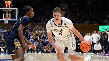 Jan 11, 2025; Durham, North Carolina, USA;  Duke basketball forward Cooper Flagg (2) drives to the basket as Notre Dame Fighting Irish guard Markus Burton (3) defends during the first half at Cameron Indoor Stadium. 