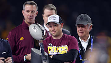 Arizona State Sun Devils head coach Kenny Dillingham looks at the trophy after winning the Big 12 Championship game.
