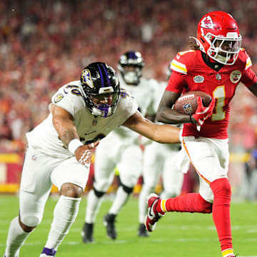 Sep 5, 2024; Kansas City, Missouri, USA; Kansas City Chiefs wide receiver Xavier Worthy (1) scores a touchdown against Baltimore Ravens linebacker Malik Harrison (40) during the first half at GEHA Field at Arrowhead Stadium. Mandatory Credit: Jay Biggerstaff-Imagn Images