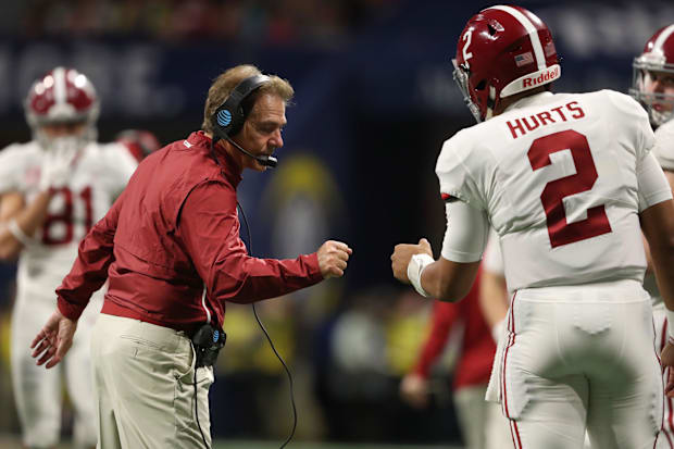 Alabama Crimson Tide head coach Nick Saban fist bumps quarterback Jalen Hurts