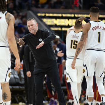 Feb 25, 2024; San Francisco, California, USA; Denver Nuggets head coach Michael Malone congratulates his players as they come off the court during the fourth quarter against the Golden State Warriors at Chase Center.