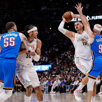 Denver Nuggets center Nikola Jokic (15) looks to pass the ball under pressure from Oklahoma City Thunder guard Alex Caruso (9) as center Isaiah Hartenstein (55) and forward Aaron Gordon (32) battle for position in the third quarter during game six of the second round for the 2025 NBA Playoffs at Ball Arena. 
