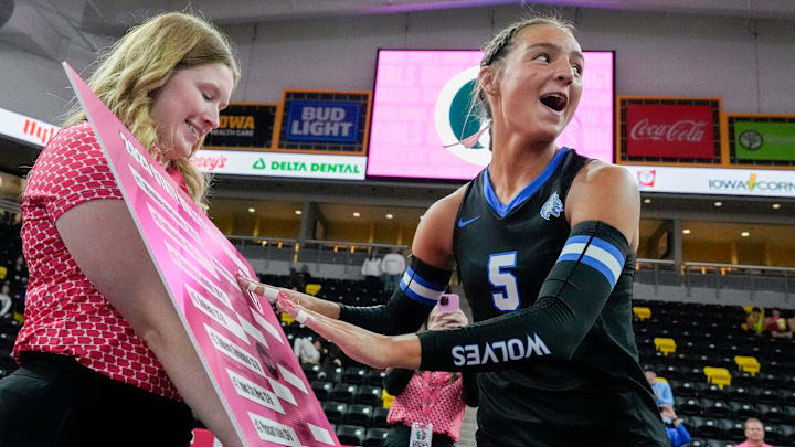 Waukee Northwest's Avery Vogt (5) adds the Wolves’ name to a bracket sheet after defeating Indianola Nov. 3, 2025 during the Class 5A Iowa high school state volleyball quarterfinals at Xtream Arena in Coralville, Iowa.