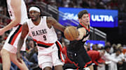 Nov 14, 2025; Houston, Texas, USA;  Houston Rockets guard Reed Sheppard (15) attempts to steal the ball from Portland Trail Blazers forward Jerami Grant (9) during the fourth quarter at Toyota Center. Mandatory Credit: Troy Taormina-Imagn Images