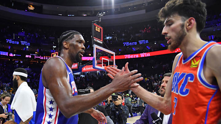 Apr 2, 2024; Philadelphia, Pennsylvania, USA; Philadelphia 76ers center Joel Embiid (21) and Oklahoma City Thunder forward Chet Holmgren (7) meet on court after 76ers win at Wells Fargo Center. Mandatory Credit: Eric Hartline-Imagn Images