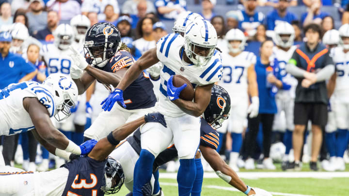 Aug 19, 2023; Indianapolis, IN; Indianapolis Colts running back Deon Jackson (35) runs the ball while Chicago Bears safety Elijah Hicks (37) defends in the first quarter at Lucas Oil Stadium.  