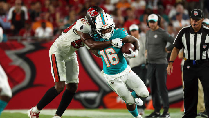 Aug 23, 2024; Tampa, Florida, USA; Miami Dolphins running back Anthony McFarland Jr. (16) runs with the ball as Tampa Bay Buccaneers linebacker Vi Jones (53) defends during the second half at Raymond James Stadium. Mandatory Credit: Kim Klement Neitzel-USA TODAY Sports