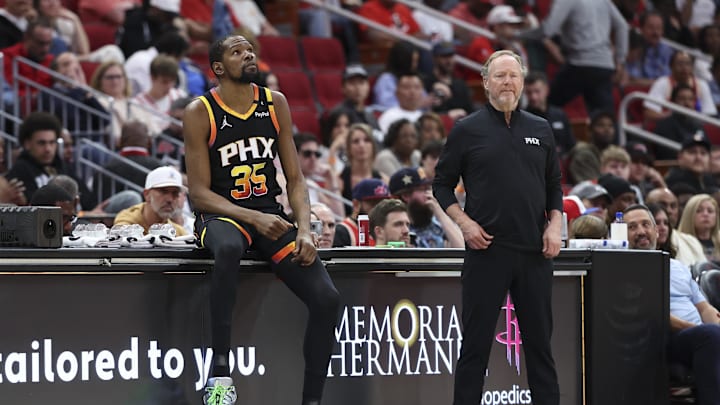 Mar 12, 2025; Houston, Texas, USA; Phoenix Suns forward Kevin Durant (35) sits on the scorers table as head coach Mike Budenholzer looks on during the second quarter against the Houston Rockets at Toyota Center. Mandatory Credit: Troy Taormina-Imagn Images Mar 12, 2025; Houston, Texas, USA; Phoenix Suns forward Kevin Durant (35) sits on the scorers table as head coach Mike Budenholzer looks on during the second quarter against the Houston Rockets at Toyota Center. Mandatory Credit: Troy Taormina-Imagn Images