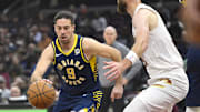 Oct 10, 2024; Cleveland, Ohio, USA; Indiana Pacers guard T.J. McConnell (9) dribbles beside Cleveland Cavaliers forward Dean Wade (32) in the first quarter at Rocket Mortgage FieldHouse. Mandatory Credit: David Richard-Imagn Images