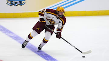 Apr 6, 2023; Tampa, Florida, USA; Minnesota forward Logan Cooley (92) controls the puck against Boston University during the second period in the semifinals of the 2023 Frozen Four college ice hockey tournament at Amalie Arena. Mandatory Credit: Nathan Ray Seebeck-Imagn Images