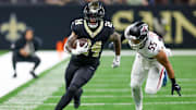 Nov 23, 2025; New Orleans, Louisiana, USA; New Orleans Saints running back Devin Neal (24) carries the ball as Atlanta Falcons linebacker Kaden Elliss (55) defends during the second half at Caesars Superdome. Mandatory Credit: Stephen Lew-Imagn Images