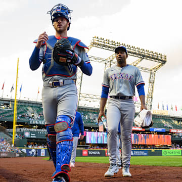 Sep 12, 2024; Seattle, Washington, USA; Texas Rangers catcher Jonah Heim (28) and starting pitcher Kumar Rocker (80) walk toward the dugout before the game against the Seattle Mariners at T-Mobile Park. Mandatory Credit: Steven Bisig-Imagn Images