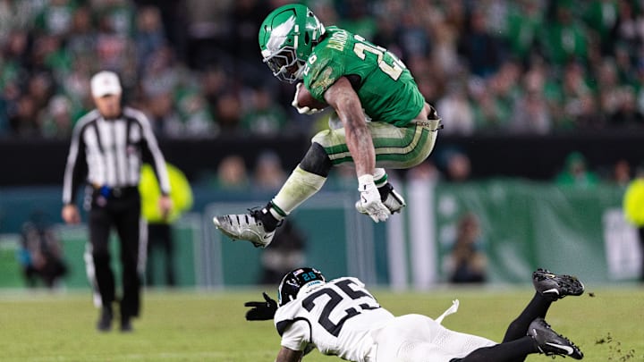 Philadelphia Eagles running back Saquon Barkley leaps over Jacksonville Jaguars cornerback Ronald Darby.