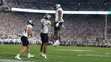 Sep 27, 2025; University Park, Pennsylvania, USA; Oregon Ducks running back Jordon Davison (0) reacts with quarterback Dante Moore (5) after scoring a touchdown against the Penn State Nittany Lions at Beaver Stadium. Mandatory Credit: Matthew O'Haren-Imagn Images