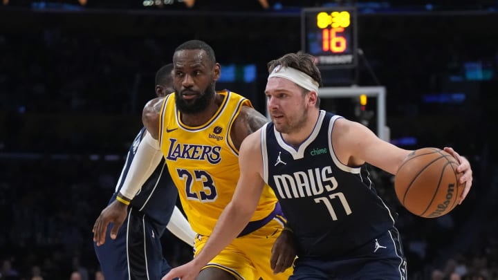 Jan 17, 2024; Los Angeles, California, USA; Dallas Mavericks guard Luka Doncic (77) dribbles the ball against Los Angeles Lakers forward LeBron James (23) in the first half at Crypto.com Arena. Mandatory Credit: Kirby Lee-USA TODAY Sports