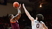 Feb 15, 2025; Blacksburg, Virginia, USA; Virginia Tech Hokies forward Tobi Lawal (1) shoots the ball over Virginia Cavaliers forward Blake Buchanan (0) during the first half at Cassell Coliseum. Mandatory Credit: Brian Bishop-Imagn Images