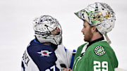 Winnipeg Jets goaltender Connor Hellebuyck shakes hands with Dallas Stars goaltender Jake Oettinger.