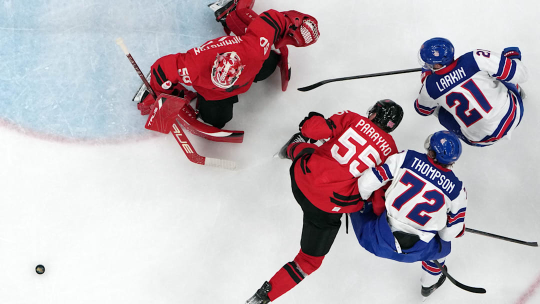 [US, Mexico & Canada customers only] Feb 22, 2026; Milan, Italy; Jordan Binnington of Canada and Colton Parayko of Canada in action with Tage Thompson of United States and Dylan Larkin of United States during the men's ice hockey gold medal game during the Milano Cortina 2026 Olympic Winter Games at Milano Santagiulia Ice Hockey Arena. Mandatory Credit: Mike Segar-Reuters via Imagn Images