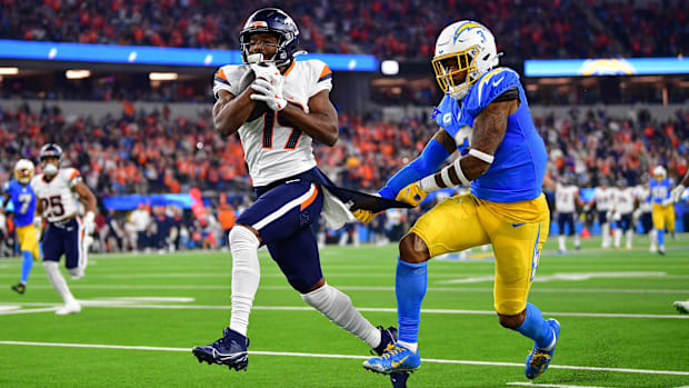 Denver Broncos wide receiver Marvin Mims Jr. (19) runs the ball ahead of Los Angeles Chargers safety Derwin James Jr. (3).