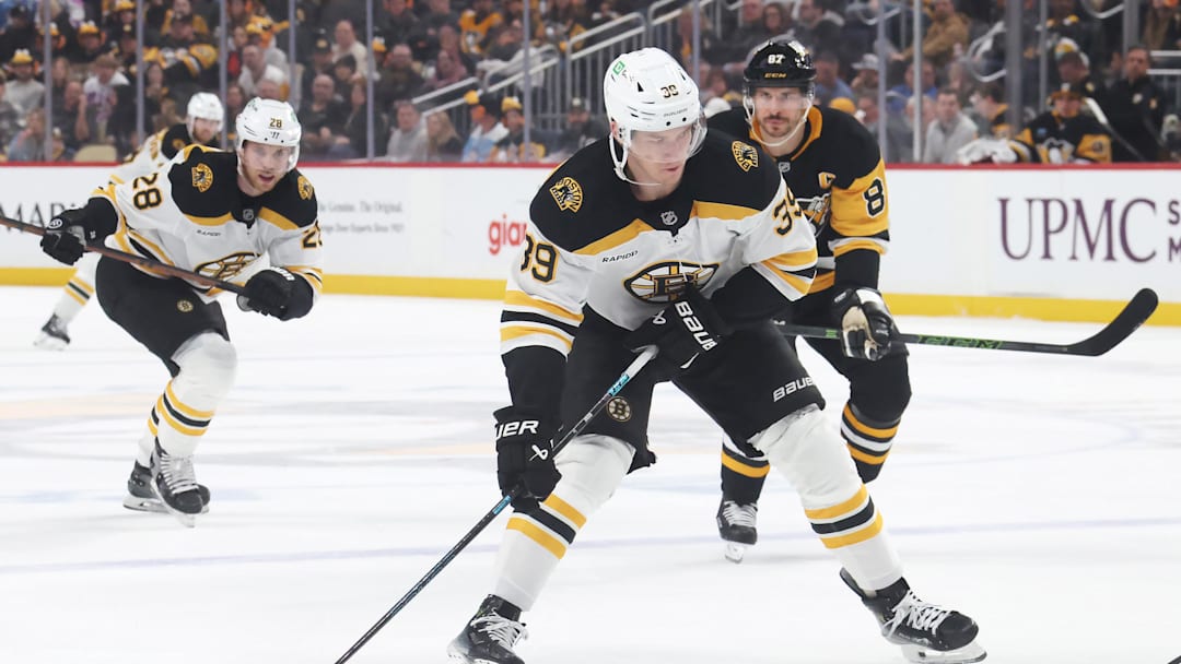 Apr 13, 2025; Pittsburgh, Pennsylvania, USA; Boston Bruins center Morgan Geekie (39) skates with the puck against the Pittsburgh Penguins during the second period at PPG Paints Arena. Mandatory Credit: Charles LeClaire-Imagn Images
