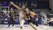 Jan 24, 2024; Houston, Texas, USA; Florida Atlantic Owls guard Nick Boyd (2) drives with the ball as Rice Owls guard Noah Shelby (1) defends during the first half at Tudor Fieldhouse. Mandatory Credit: Troy Taormina-Imagn Images
