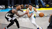 Apr 22, 2025; Indianapolis, Indiana, USA; Indiana Pacers guard Tyrese Haliburton (0) dribbles the ball while Milwaukee Bucks guard Damian Lillard (0) defends during game two of first round for the 2024 NBA Playoffs at Gainbridge Fieldhouse. Mandatory Credit: Trevor Ruszkowski-Imagn Images