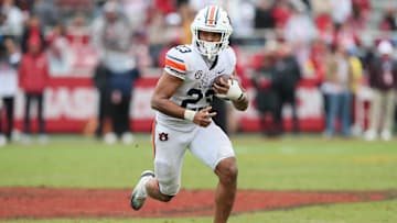 Oct 25, 2025; Fayetteville, Arkansas, USA; Auburn Tigers running back Jeremiah Cobb (23) rushes during the fourth quarter against the Arkansas Razorbacks at Donald W. Reynolds Razorback Stadium. Mandatory Credit: Nelson Chenault-Imagn Images