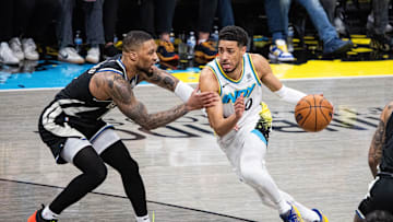 Apr 22, 2025; Indianapolis, Indiana, USA; Indiana Pacers guard Tyrese Haliburton (0) dribbles the ball while Milwaukee Bucks guard Damian Lillard (0) defends during game two of first round for the 2024 NBA Playoffs at Gainbridge Fieldhouse. Mandatory Credit: Trevor Ruszkowski-Imagn Images