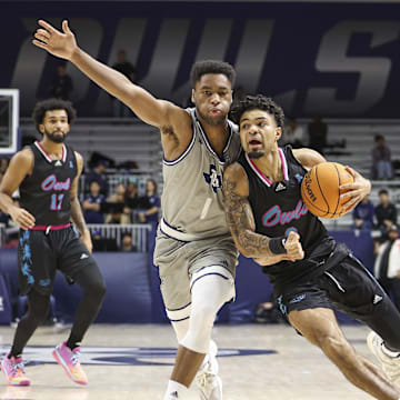 Jan 24, 2024; Houston, Texas, USA; Florida Atlantic Owls guard Nick Boyd (2) drives with the ball as Rice Owls guard Noah Shelby (1) defends during the first half at Tudor Fieldhouse. Mandatory Credit: Troy Taormina-Imagn Images