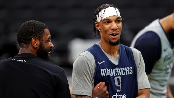 Jun 5, 2024; Boston, MA, USA;  Dallas Mavericks guard Kyrie Irving (11) and guard A.J. Lawson (9) laugh with teammates during the NBA Finals Media Day at TD Garden. Mandatory Credit: Peter Casey-USA TODAY Sports