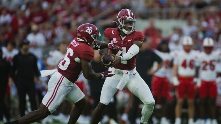 Aug 31, 2024; Tuscaloosa, Alabama, USA; Alabama Crimson Tide quarterback Jalen Milroe (4) passes off the ball to Jam Miller (26) during the first quarter at Bryant-Denny Stadium. Mandatory Credit: Will McLelland-USA TODAY Sports