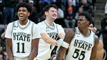 Dec 21, 2024; East Lansing, Michigan, USA;  Michigan State Spartans including guard Jase Richardson (11)  forward Frankie Fidler (8) and forward Coen Carr (55) celebrate a big play by Carr against the Florida Atlantic Owls during the second halfat Jack Breslin Student Events Center. Mandatory Credit: Dale Young-Imagn Images