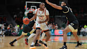 Jan 11, 2025; Coral Gables, Florida, USA; Miami Hurricanes guard Paul Djobet (10) dribbles the basketball as Wake Forest Demon Deacons forward Efton Reid III (4) defends during the first half at Watsco Center. Mandatory Credit: Sam Navarro-Imagn Images