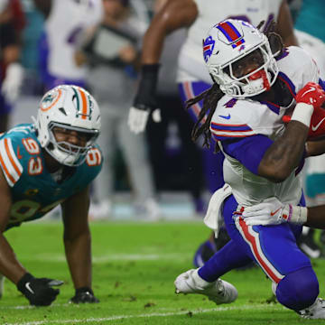 Buffalo Bills running back James Cook (4) runs with the football against Miami Dolphins cornerback Kendall Fuller (29) during the first quarter at Hard Rock Stadium.