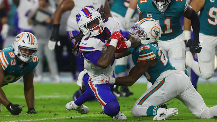 Buffalo Bills running back James Cook (4) runs with the football against Miami Dolphins cornerback Kendall Fuller (29) during the first quarter at Hard Rock Stadium.