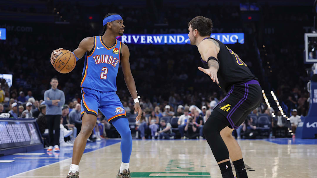 Apr 2, 2026; Oklahoma City, Oklahoma, USA; Oklahoma City Thunder guard Shai Gilgeous-Alexander (2) dribbles down the court as Los Angeles Lakers guard Luka Doncic (77) defends during the second half at Paycom Center. Mandatory Credit: Alonzo Adams-Imagn Images