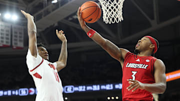 Dec 3, 2025; Fayetteville, Arkansas, USA; Louisville Cardinals guard Ryan Conwell (3) shoots against Arkansas Razorbacks wing Karter Knox (11) during the second half at Bud Walton Arena. Arkansas won 89-80. Mandatory Credit: Nelson Chenault-Imagn Images