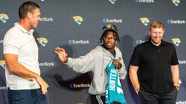 The Jacksonville Jaguars’ first-round pick, Colorado Buffaloes wide receiver and defensive back Travis Hunter, center, throws