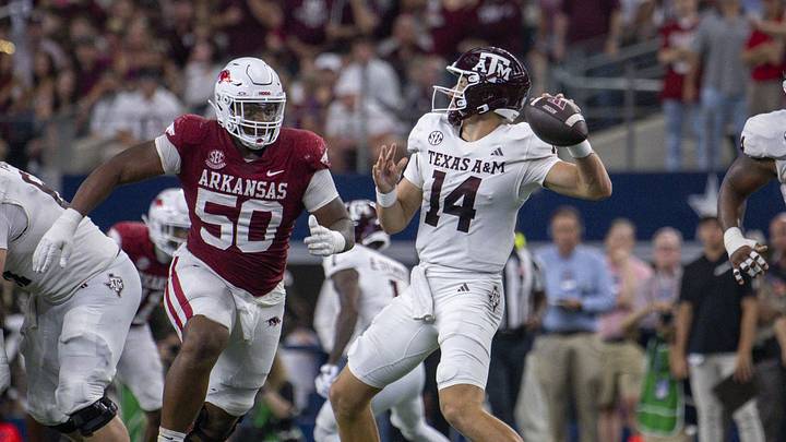 Sep 30, 2023; Arlington, Texas, USA; Texas A&M Aggies quarterback Max Johnson (14) passes the ball over Arkansas Razorbacks defensive lineman Eric Gregory (50) during the second half at AT&T Stadium. Mandatory Credit: Jerome Miron-USA TODAY Sports