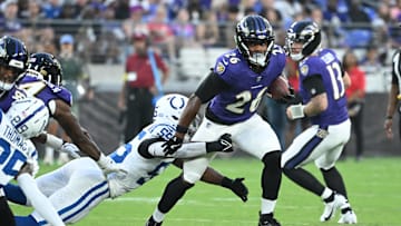 Aug 7, 2025; Baltimore, Maryland, USA; Baltimore Ravens running back Rasheen Ali (26) breaks out of a tackle by Indianapolis Colts defensive end Isaiah Land (55) during the second quarter at M&T Bank Stadium. Mandatory Credit: Rafael Suanes-Imagn Images