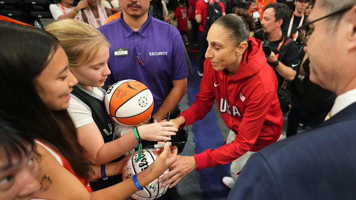 Team USA guard Diana Taurasi (12) signs autographs for fans after the WNBA All-Star Game at Footprint Center in Phoenix on July 20, 2024.
