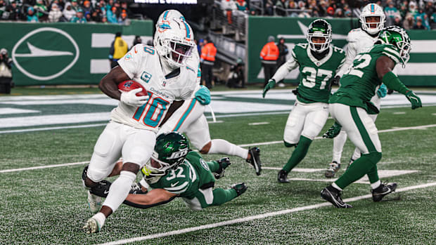 Jan 5, 2025; East Rutherford, New Jersey, USA; Miami Dolphins wide receiver Tyreek Hill (10) is tackled by New York Jets runn
