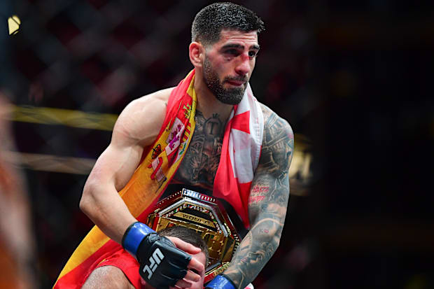 Ilia Topuria celebrates his championship victory against Alexander Volkanovski during UFC 298 at Honda Center.