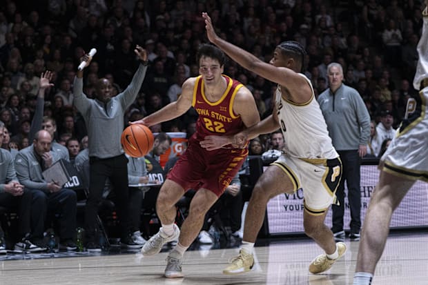 Iowa State forward Milan Momcilovic dribbles the ball around Purdue guard C.J. Cox.