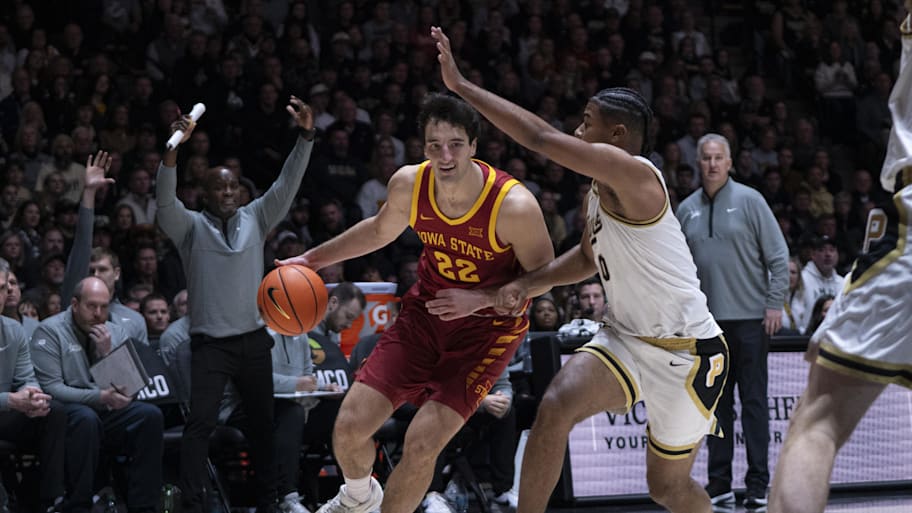 Iowa State forward Milan Momcilovic dribbles the ball around Purdue guard C.J. Cox.