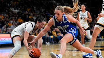 Iowa guard Taylor McCabe (2) and Drake guard Peyton McCabe (11) reach for a loose ball Nov. 13, 2025 at Carver-Hawkeye Arena in Iowa City, Iowa.