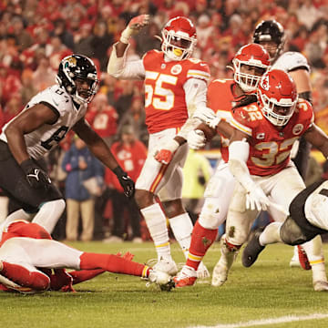 Jan 21, 2023; Kansas City, Missouri, USA; Jacksonville Jaguars running back Travis Etienne Jr. (1) scores a touchdown against the Kansas City Chiefs during the second half in the AFC divisional round game at GEHA Field at Arrowhead Stadium. Mandatory Credit: Denny Medley-Imagn Images